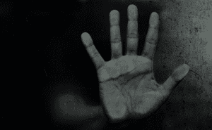 Ghost hand reaching out of the dark.